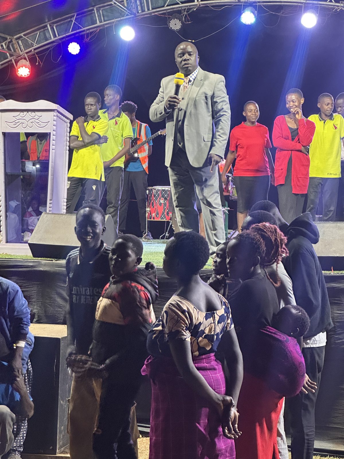 Preaching the Word with the youth choir standing in support.